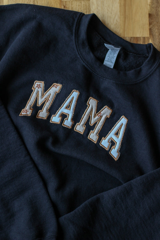 Crewneck sweater with the word "Mama" embroidered on the front.